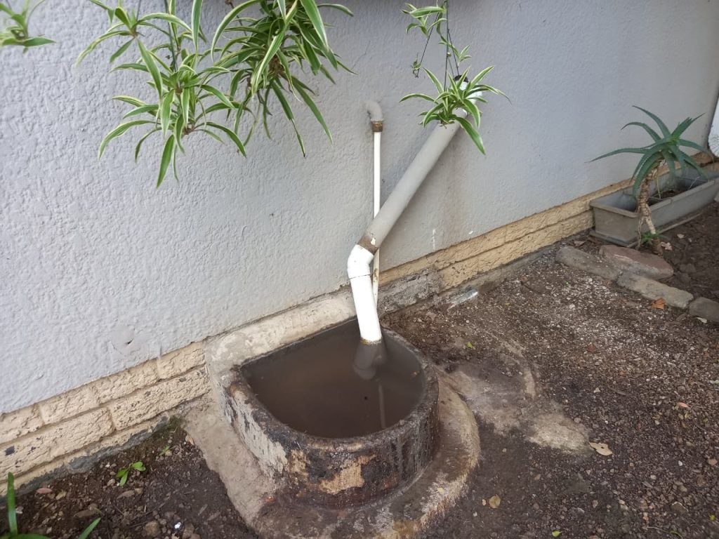 Blocked drain inspection point with standing water in Johannesburg