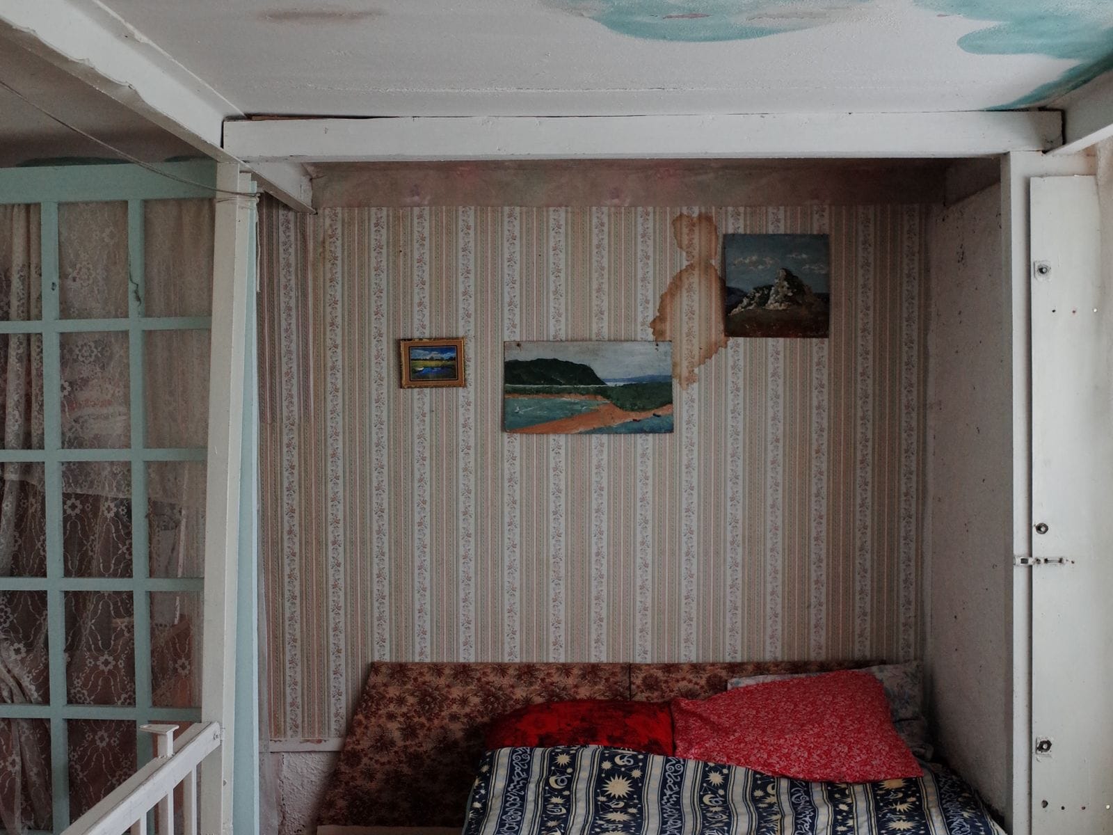 Water stains and paint damage on a ceiling caused by a hidden leak